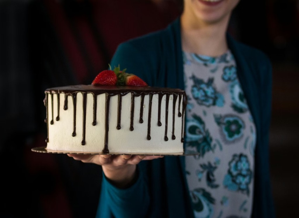 White cake with chocolate ganache and strawberries